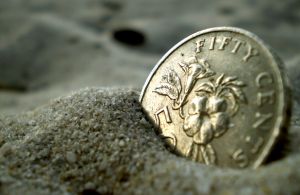 Coin in sand